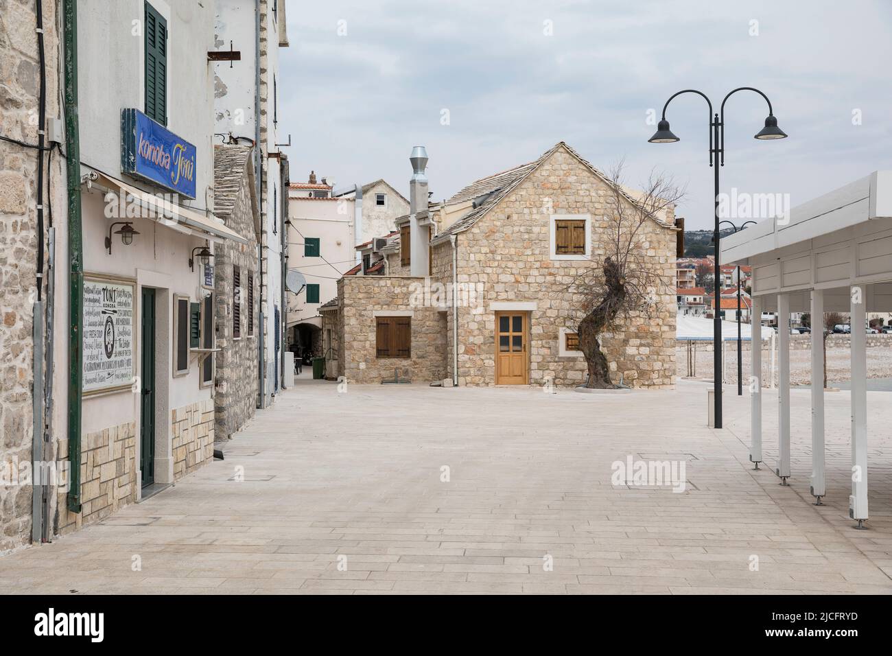 Typical houses and closed restaurant in winter on the coastal promenade, Primosten, Sibenik-Knin County, Dalmatia, Croatia, Europe Stock Photo