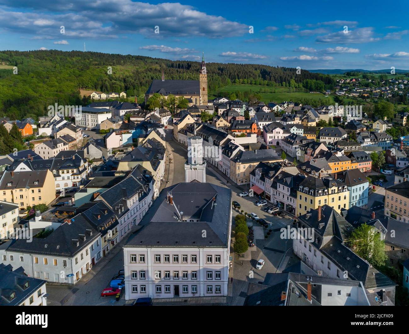 City center of Schneeberg: The Saxon town of Schneeberg is located on the Silberstrasse in the upper Western Ore Mountains. View over the town hall to the striking St. Wolfgang Church, which can be seen from afar. Stock Photo