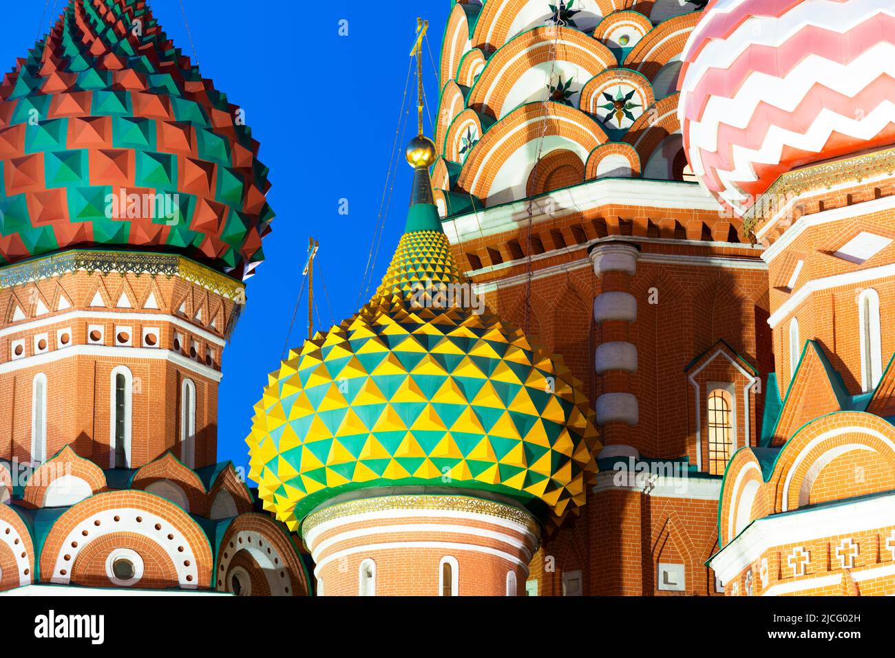 Close-up of the domes of Saint Basil's Cathedral lit up at night, Moscow, Russia Stock Photo