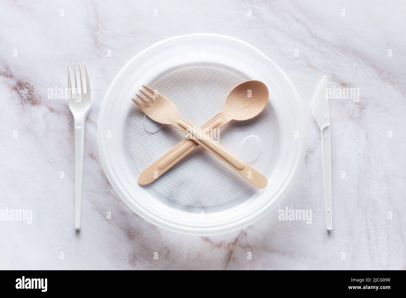 ban on plastic dishes. plastic plate and wooden fork and spoon in the