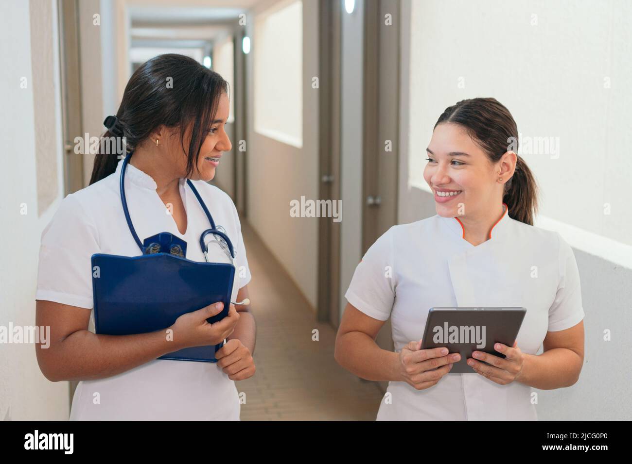 Female doctors talking while walking on hospital Stock Photo