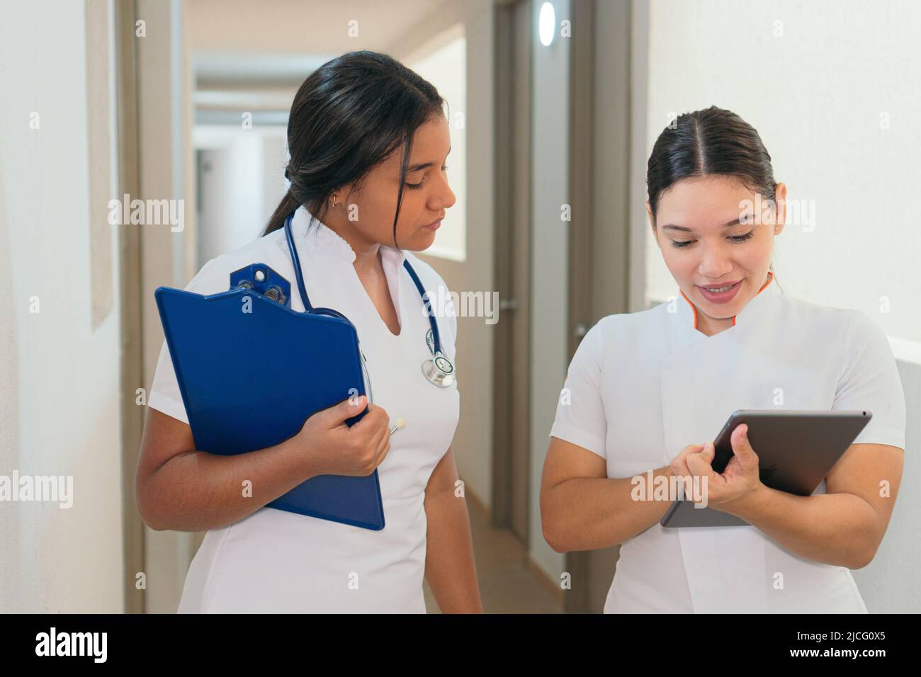 Female doctors talking while walking on hospital Stock Photo