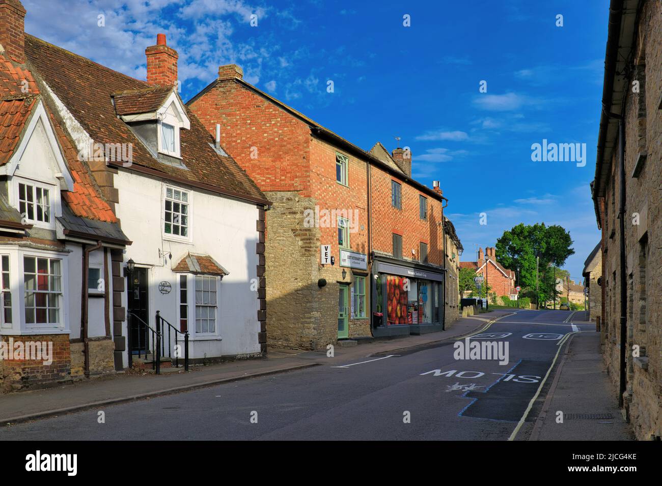 Sharnbrook, Bedfordshire, England, UK - Co-op shop, veterinary clinic and cottages in the village high street on a sunny morning Stock Photo