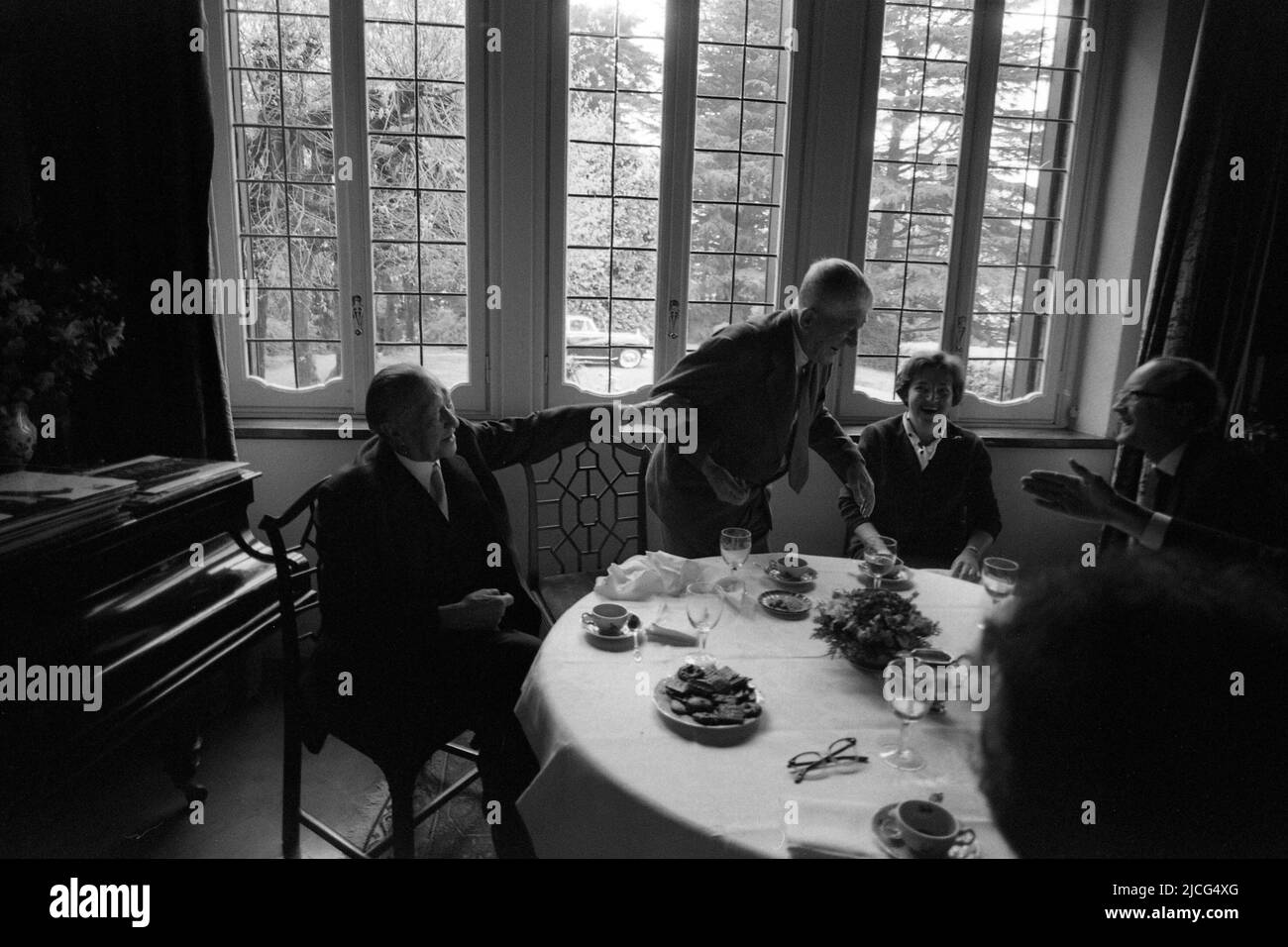 Oskar KOKOSCHKA (centre), Austria, painter, sits with his wife Olda and former Federal Chancellor Konrad ADENAUER, CDU, at a table, coffee table, they joke, friendly, April 15, 1966 Stock Photo