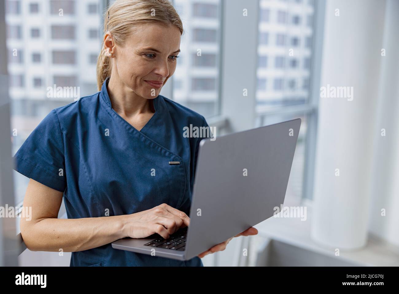 Female healthcare worker using laptop while working at doctor's office