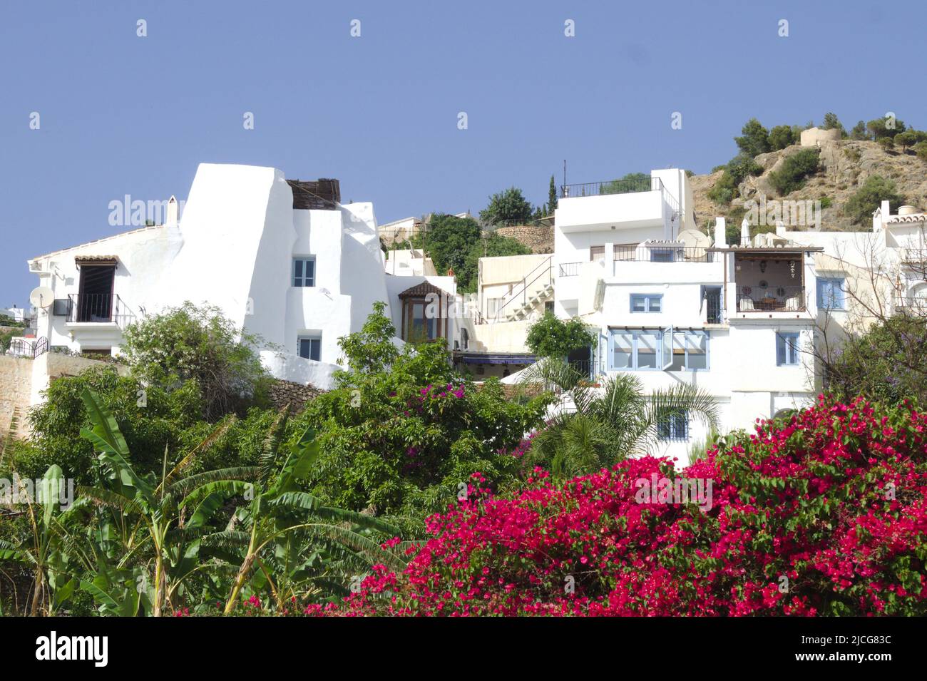 Frigiliana village, Spain. Beautiful, historic mountain village on the Costa del Sol.  Colorful flowers with a background of the historic Moorish old Stock Photo