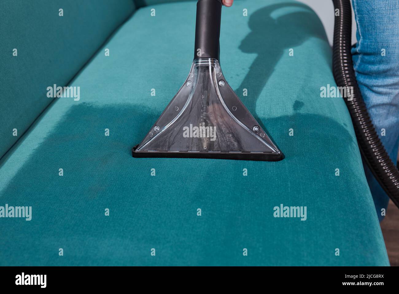Dry cleaning worker removing dirt from sofa indoors Stock Photo Alamy