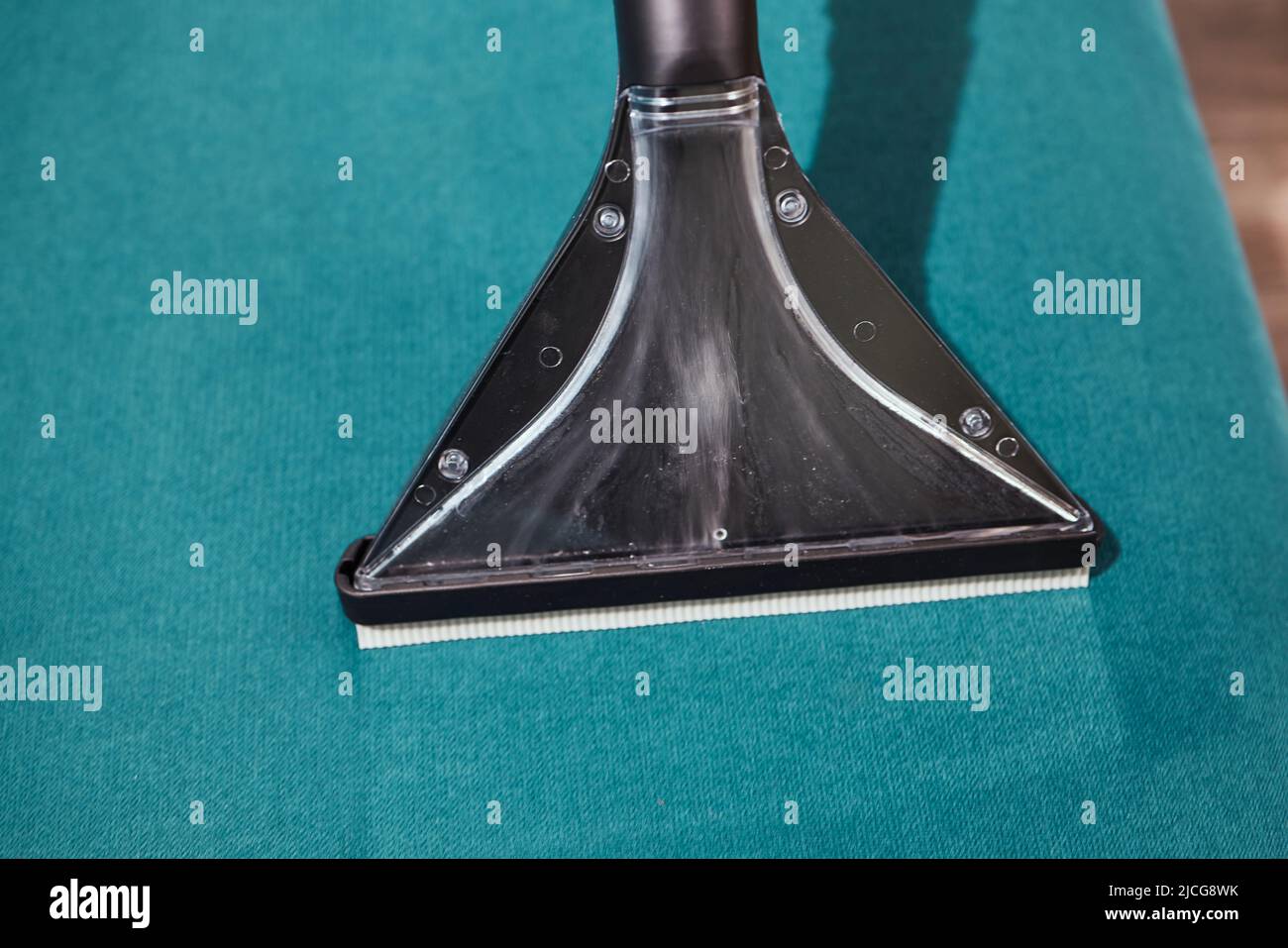 Dry cleaning worker removing dirt from sofa indoors Stock Photo Alamy