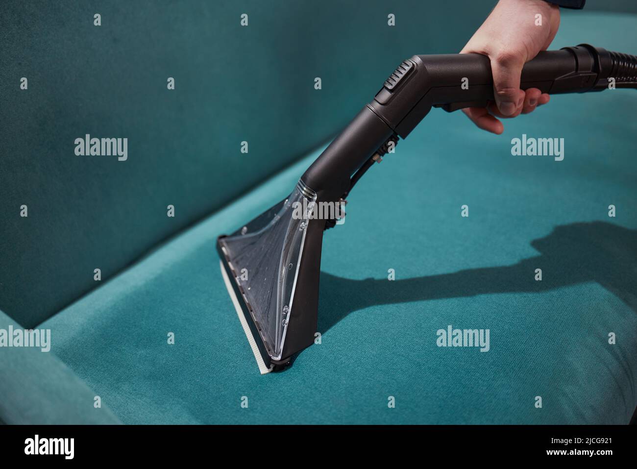 Dry cleaning worker removing dirt from sofa indoors Stock Photo Alamy