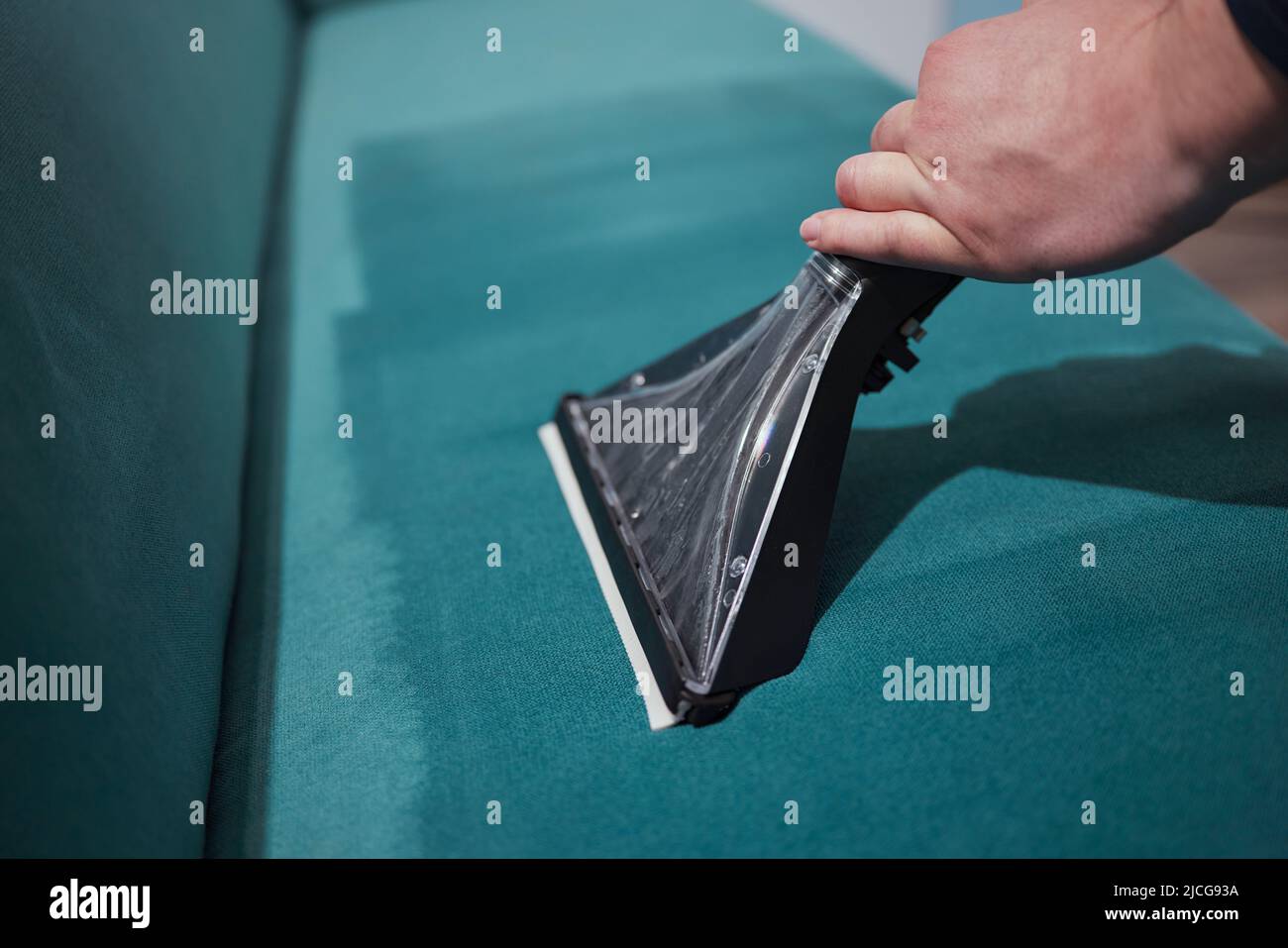 Dry cleaning worker removing dirt from sofa indoors Stock Photo Alamy