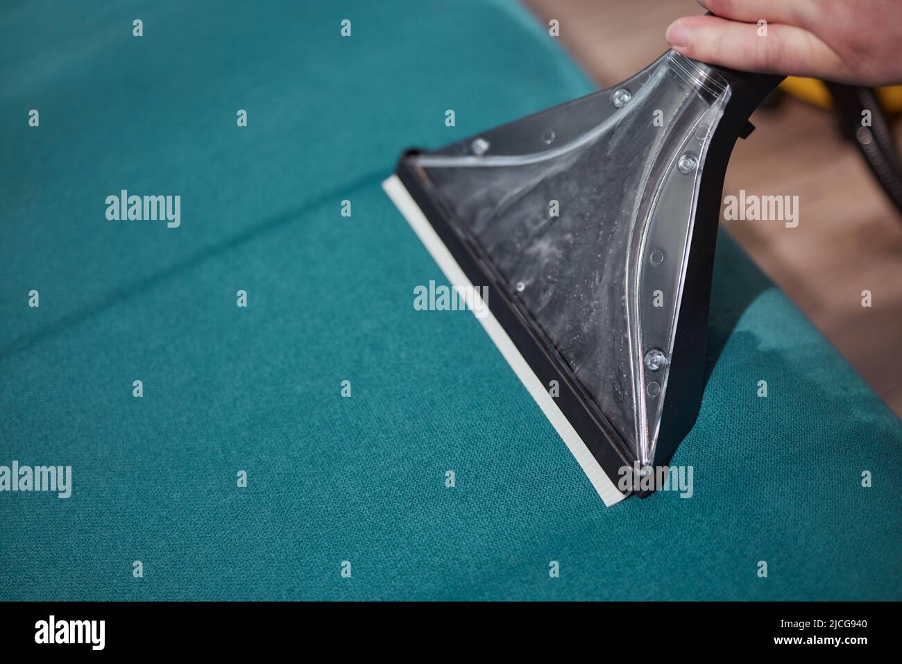 Dry cleaning worker removing dirt from sofa indoors Stock Photo Alamy