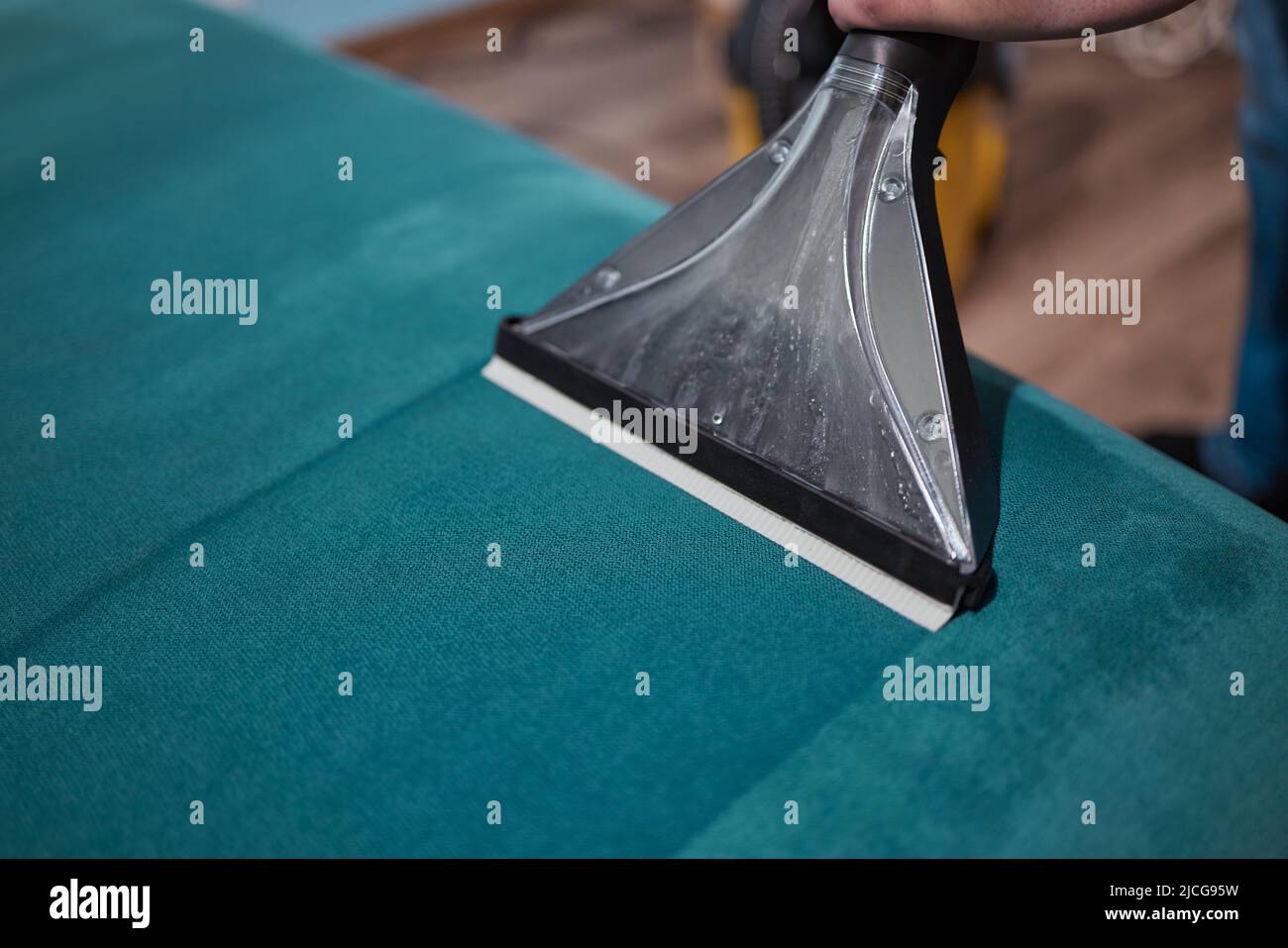 Dry cleaning worker removing dirt from sofa indoors Stock Photo Alamy