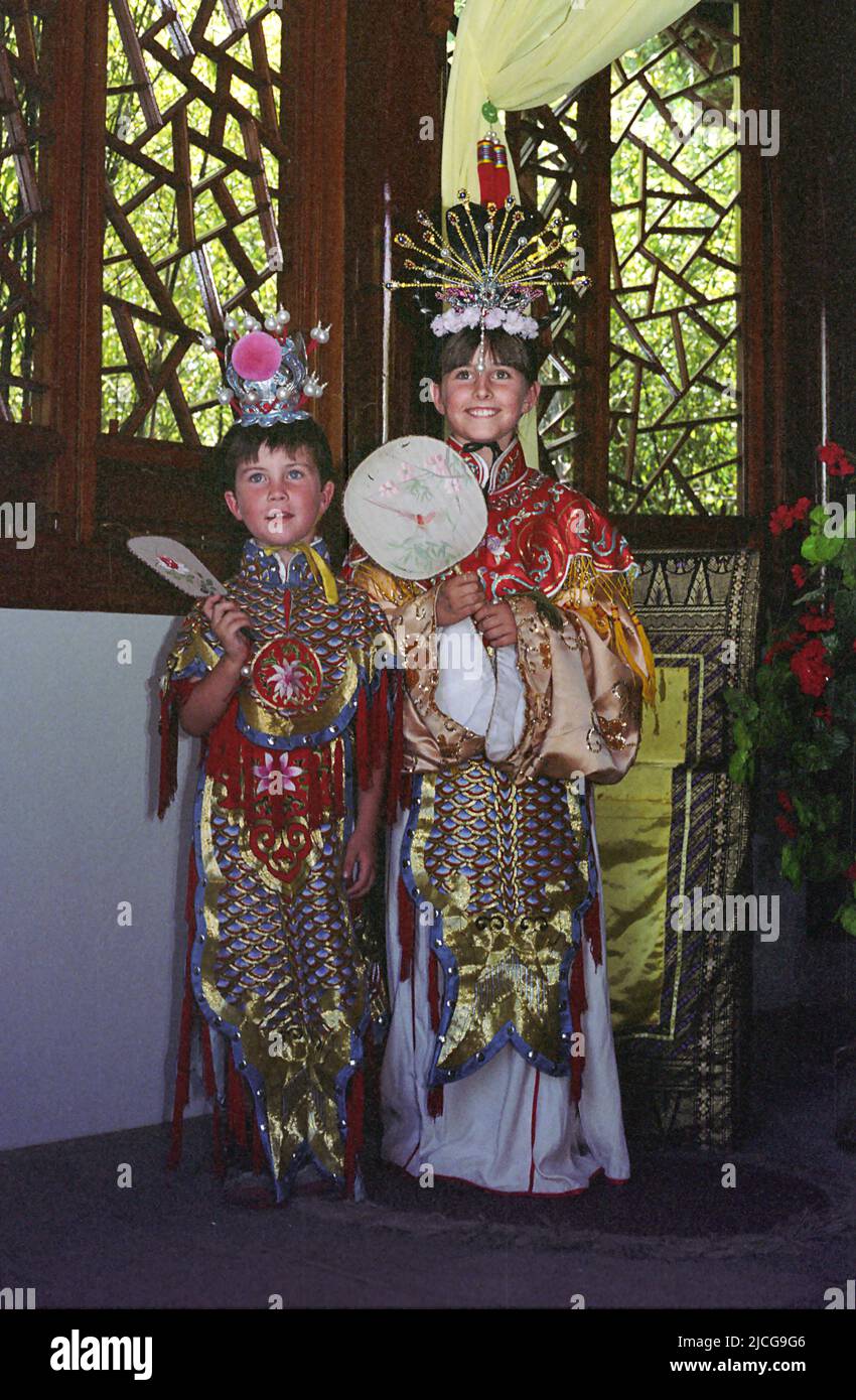 Two children dressed up in traditional Chinese costume, Chinese Garden of Friendship, Darling Harbour, Sydney, NSW, Australia.  MODEL RELEASED Stock Photo