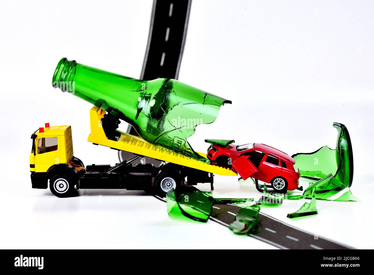 tow Truck transporting toy car with accident drunk car driver Stock Photo