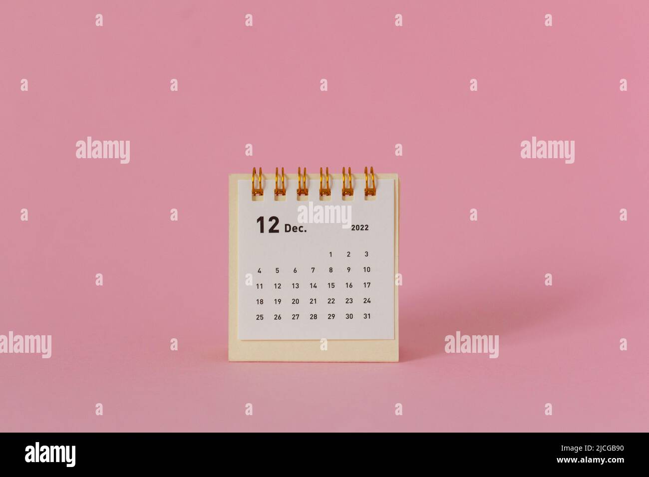 Desktop calendar for December 2022 on a pink background Stock Photo Alamy