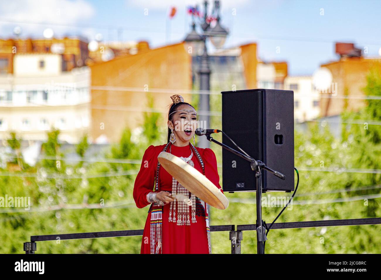 Omsk, Russia. June 12, 2022. Russia Day. Vocal composition with a tambourine of a woman-representative of the national ethnic group. Stock Photo