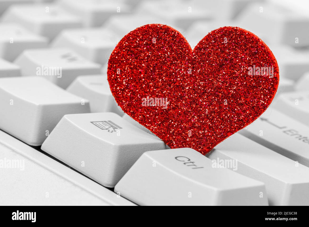 Single red heart on computer keyboard. Internet dating concept. Stock Photo