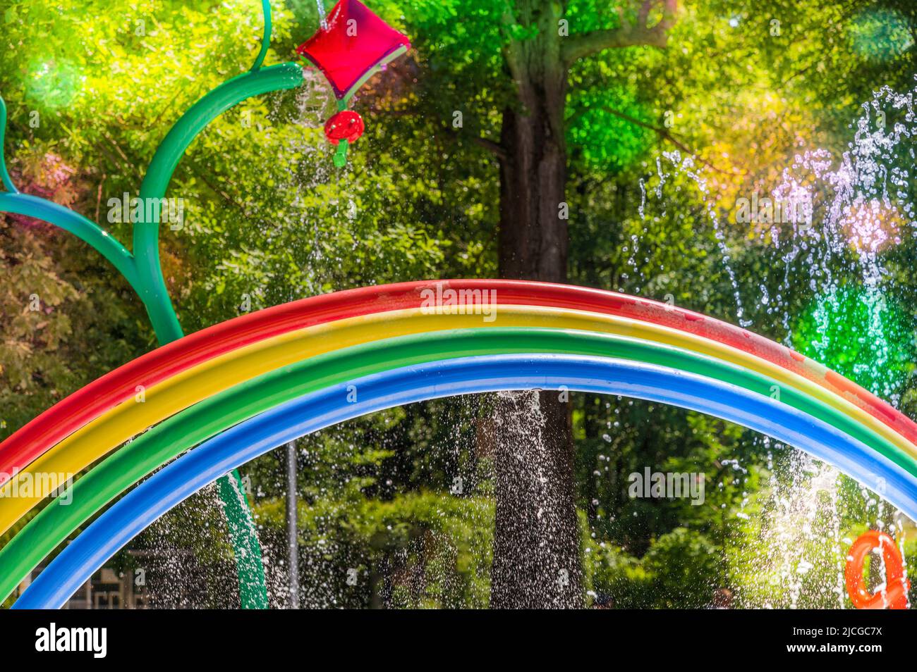 Colorful waterpark for kids with funny flower showers and a rainbow