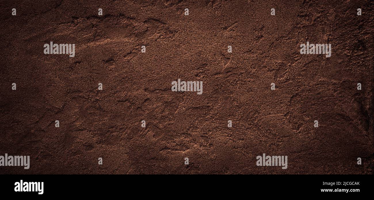Dark chokolate brown sugar-like grainy texture background Stock Photo