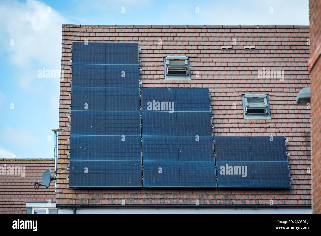 Solar panels mounted on the roof of a modern new-build house in England ...