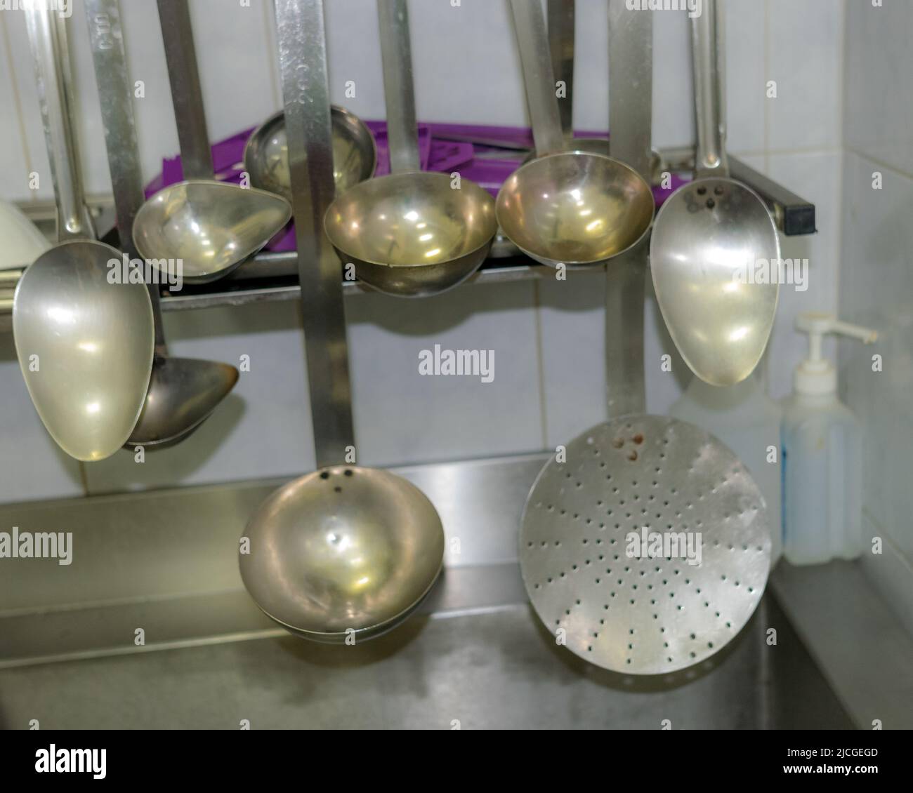 school kitchen canteen, metal cups of different shapes and sizes on the