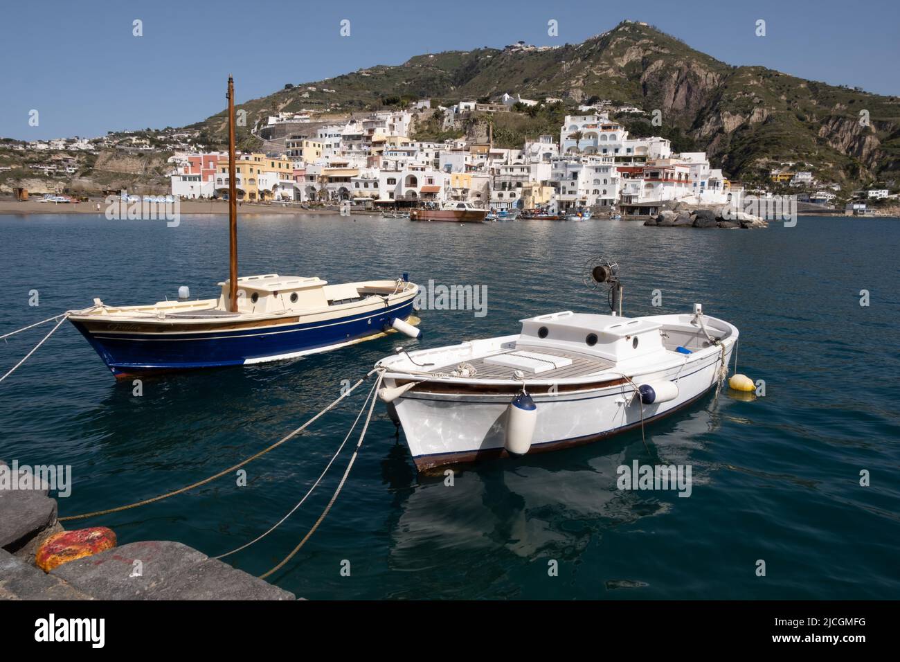 Fishing boats in the port in front of small village Stock Photo