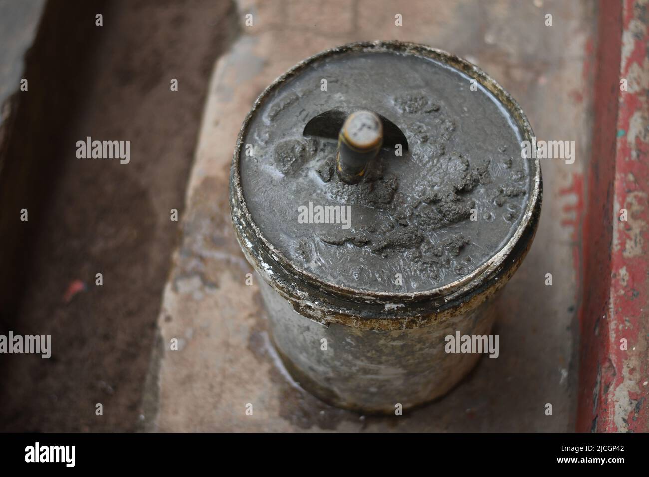 Mixed concrete Plaster on a bucket. There's a mason spoon in it. Stock Photo