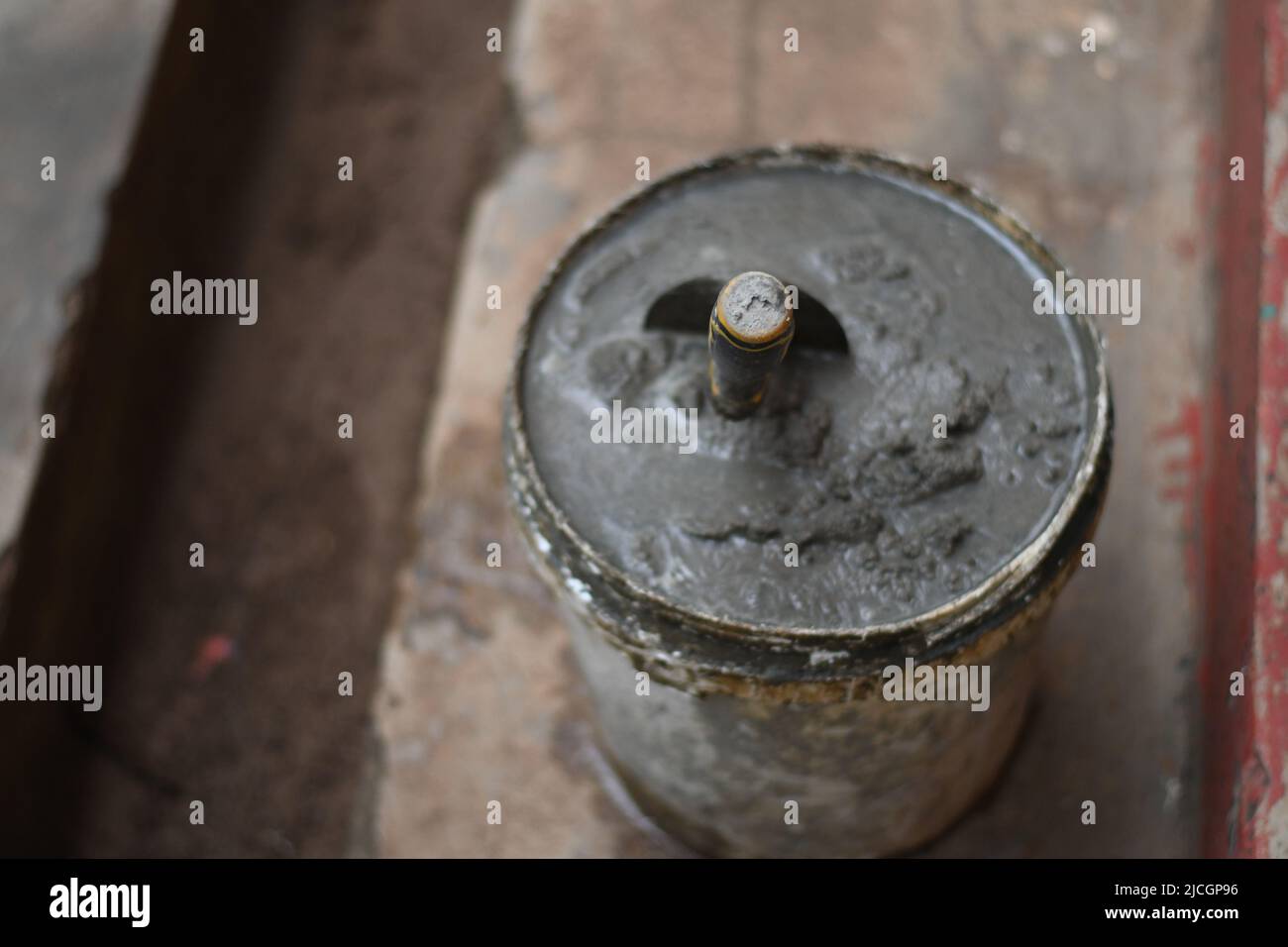 Mixed concrete Plaster on a bucket. There's a mason spoon in it. Stock Photo
