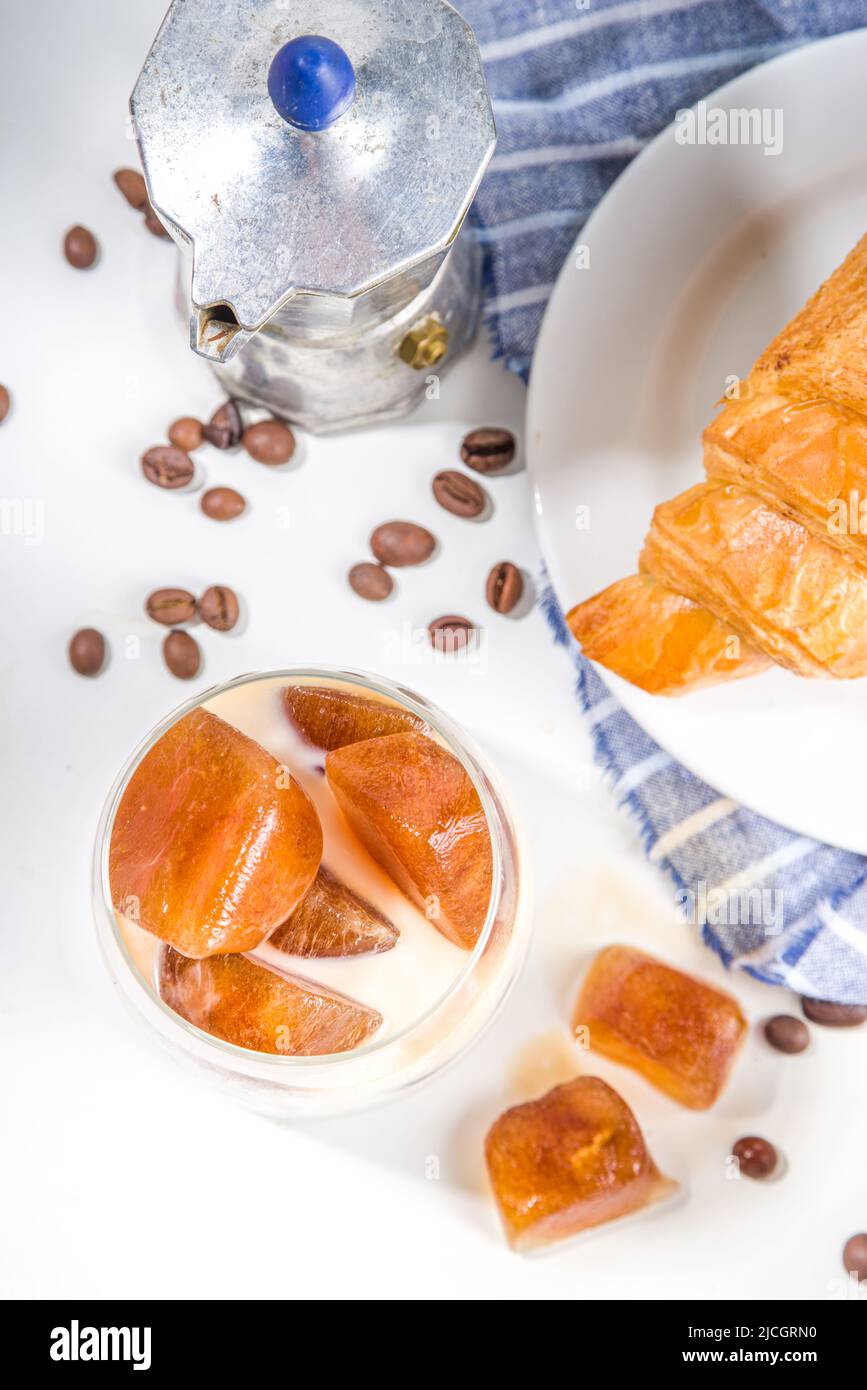 Cold coffee cocktail with frozen coffee espresso ice cubes and milk