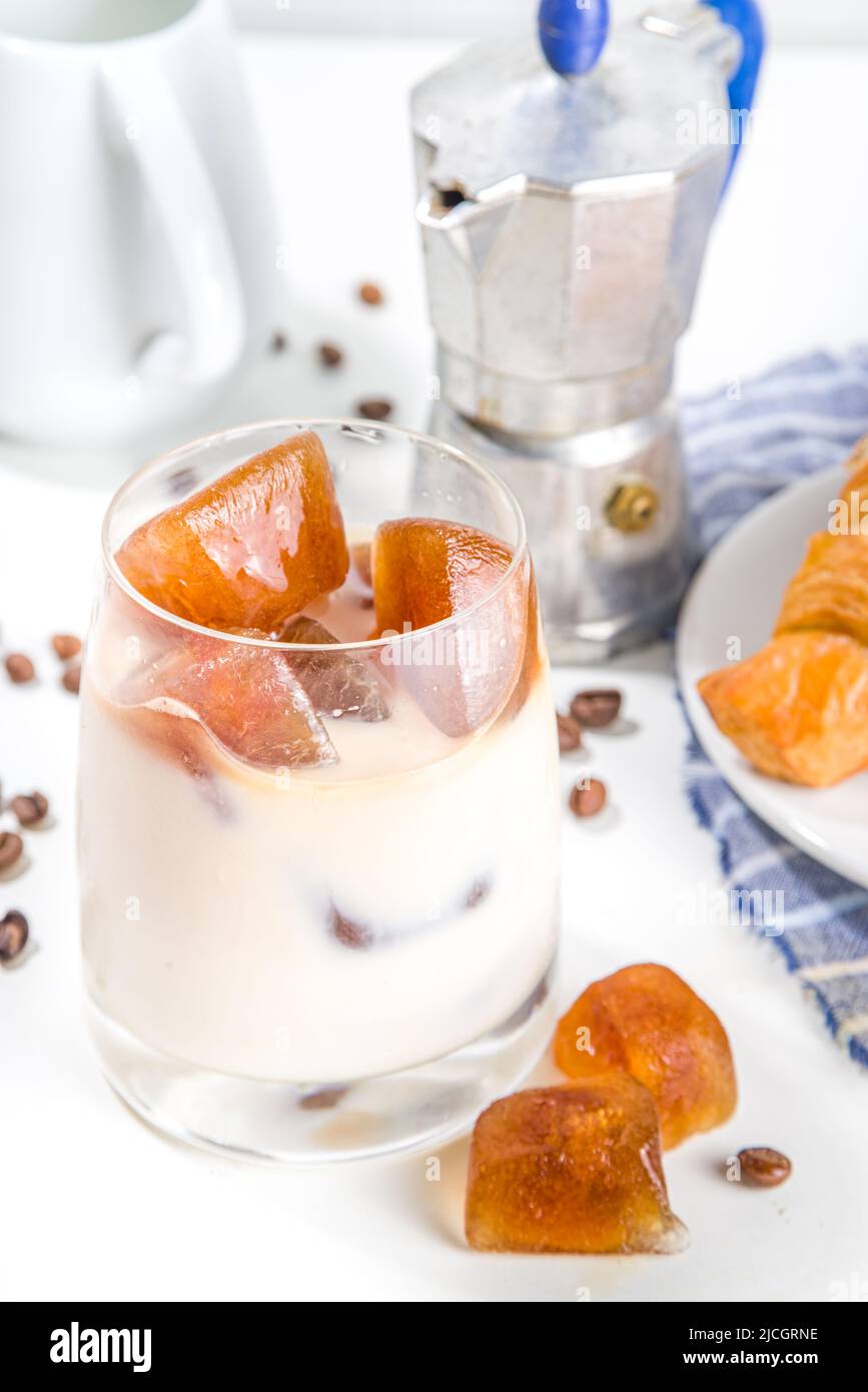 Cold coffee cocktail with frozen coffee espresso ice cubes and milk