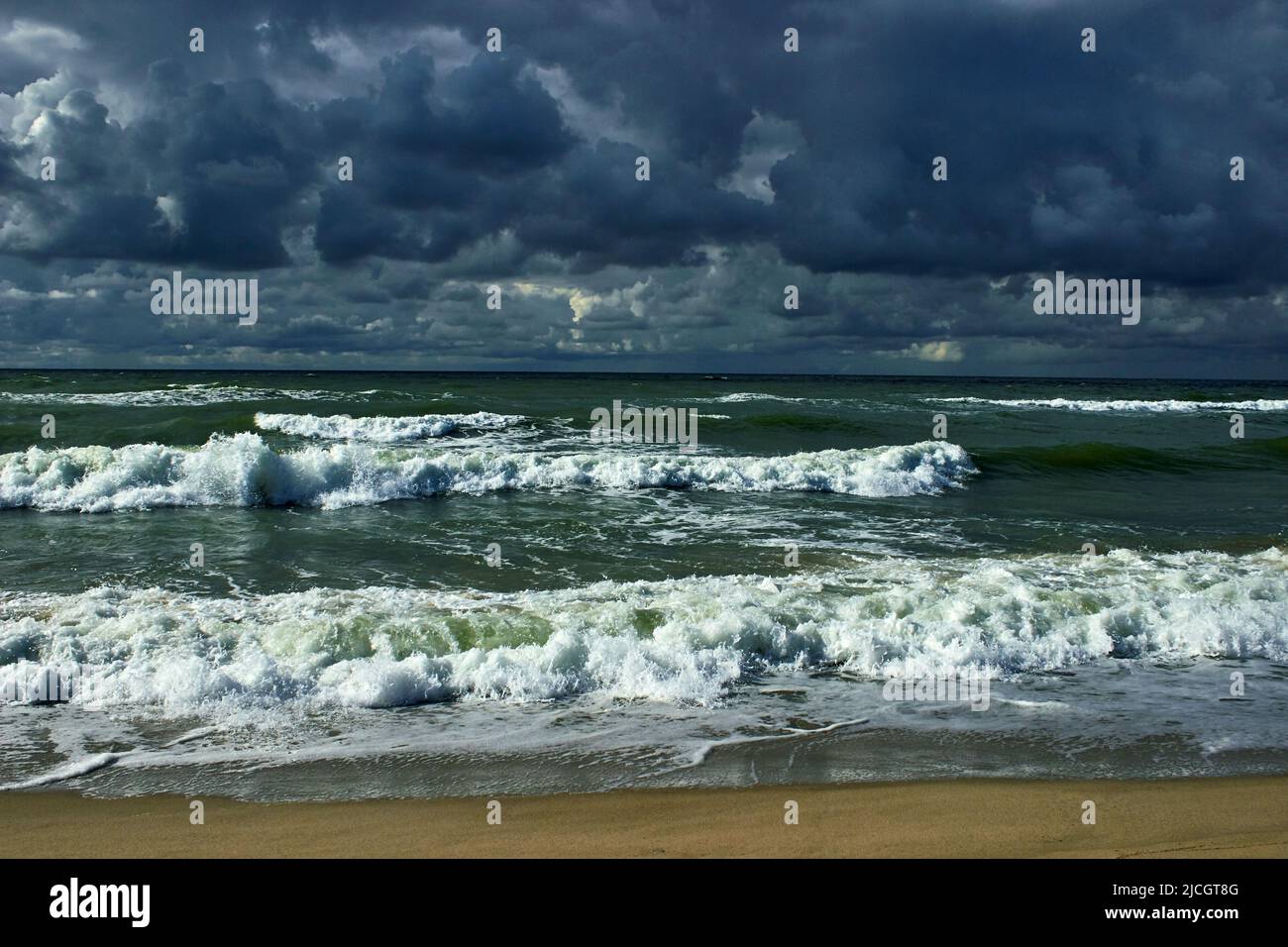 Dramatic sky with dark clouds and stormy sea with rolling waves. Baltic ...