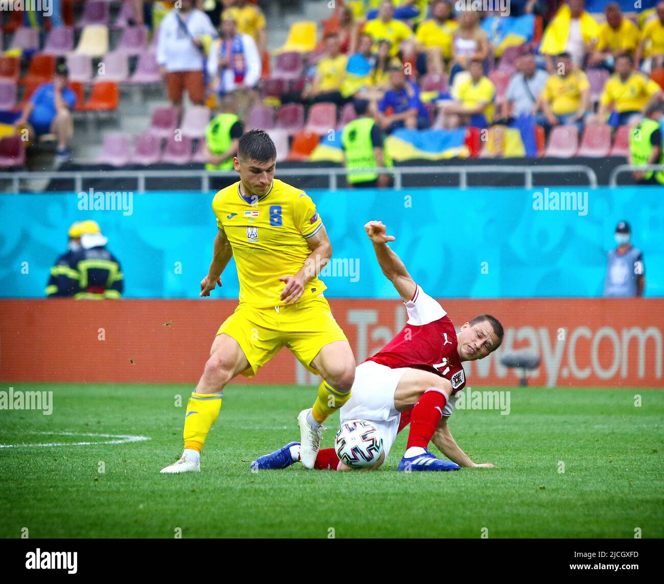BUCHAREST, ROMANIA - JUNE 21, 2021: Ruslan Malinovskyi of Ukraine (L) fights for a ball with Stefan Lainer of Austria during their UEFA EURO 2020 game at National Arena Bucharest stadium Stock Photo