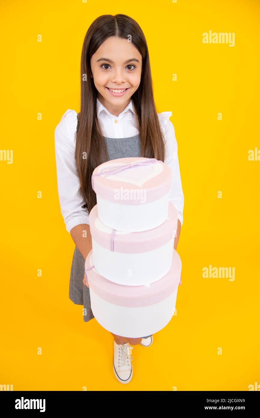 Portrait of a teenager child girl holding present box isolated over ...