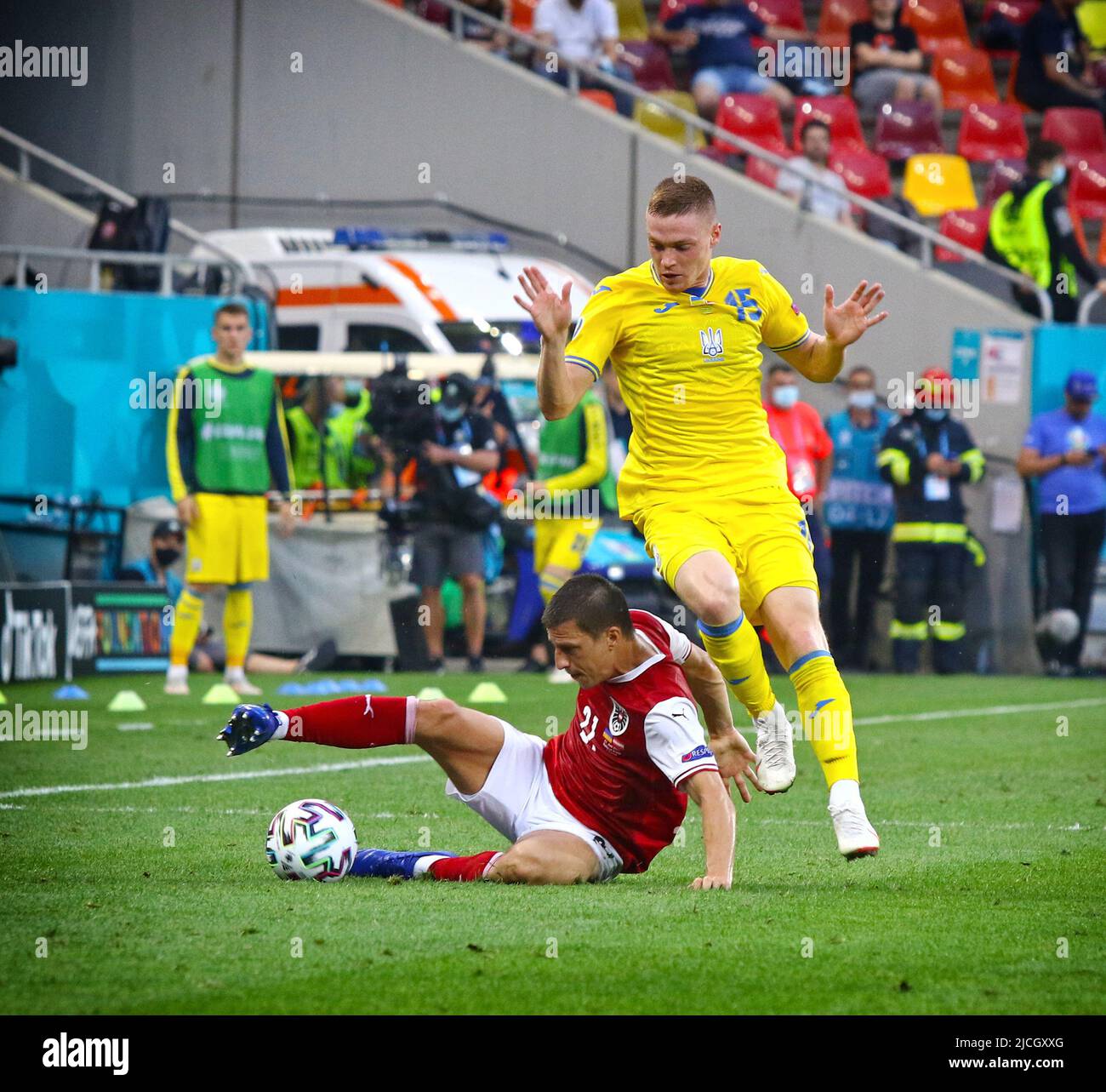 BUCHAREST, ROMANIA - JUNE 21, 2021: Stefan Lainer of Austria (L) fights for a ball with Viktor Tsygankov of Ukraine during their UEFA EURO 2020 game at National Arena Bucharest stadium Stock Photo