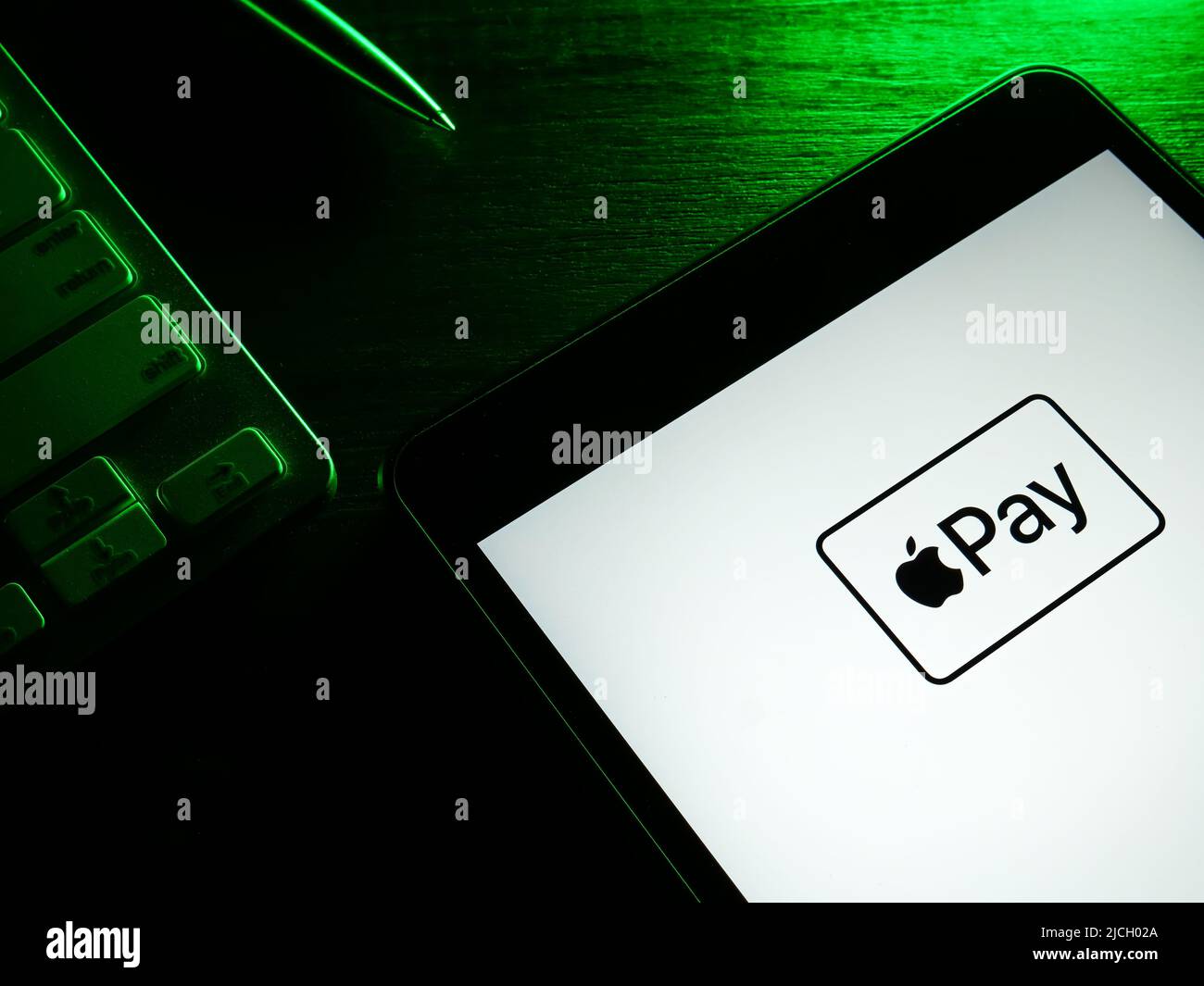 KYIV, UKRAINE - May 26, 2022. Tablet with Apple Pay logo in the dark. Stock Photo