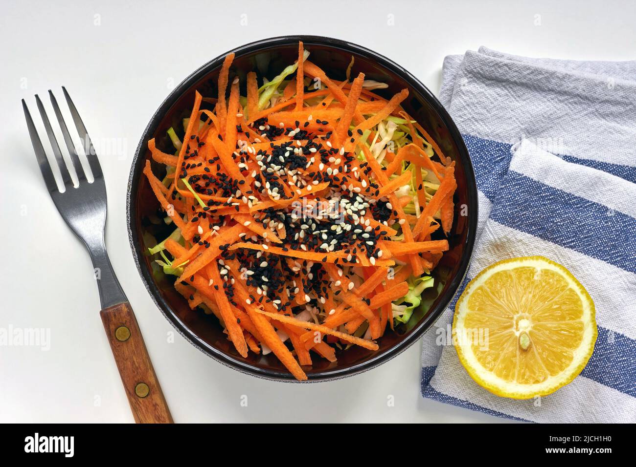 Cabbage and carrot salad with lemon dressing and sesame and black cumin