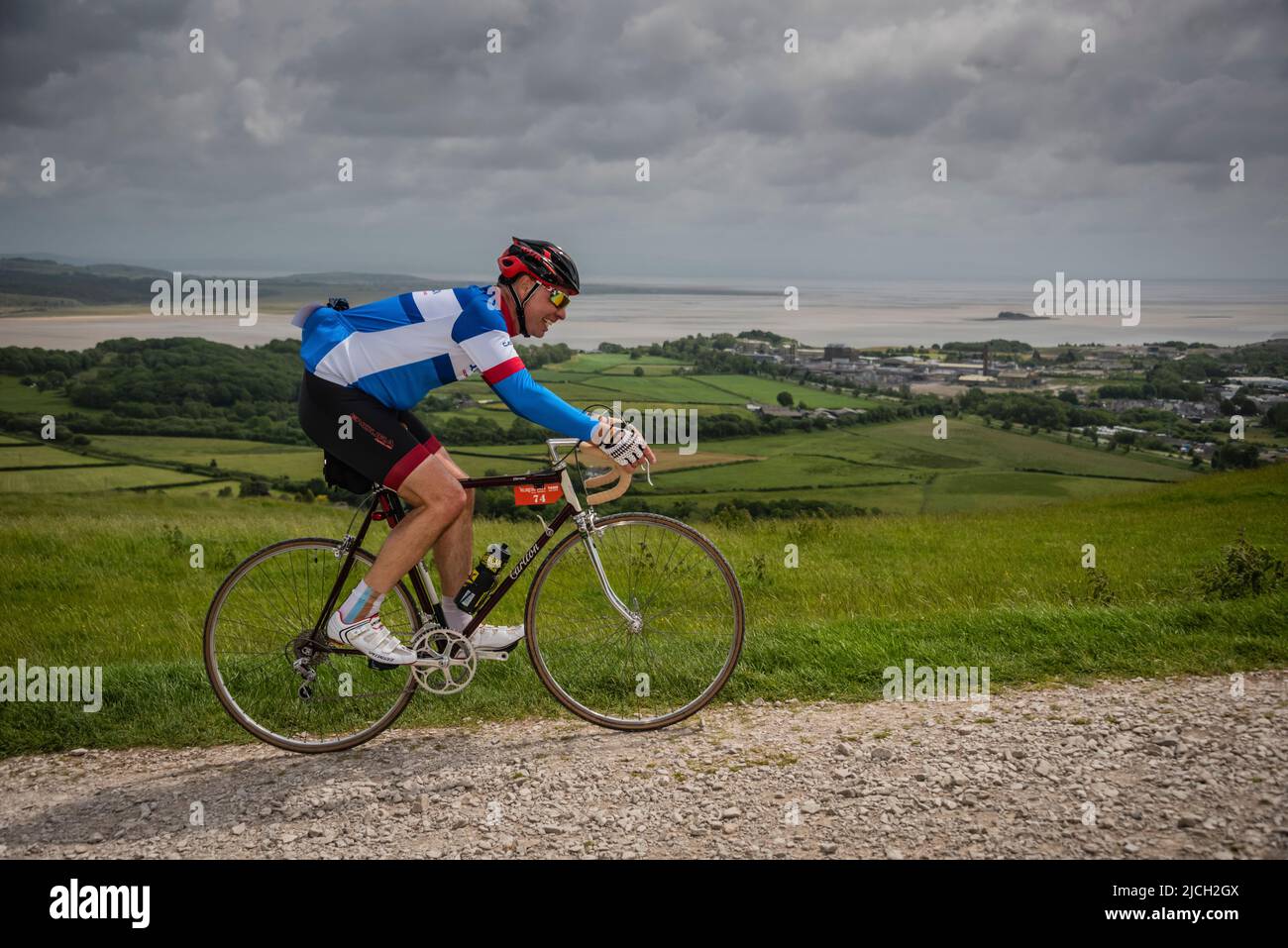 A male cyclist in the Veloretro vintage cycling event, Ulverston, Cumbria, UK. Stock Photo