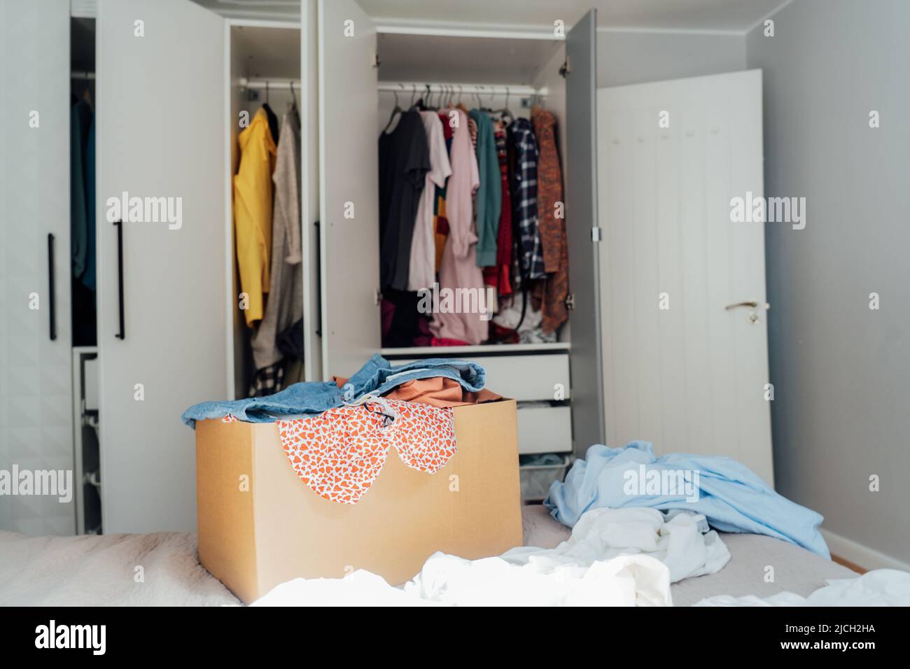 A cardboard box of selected clothes for donating to a Charity shop