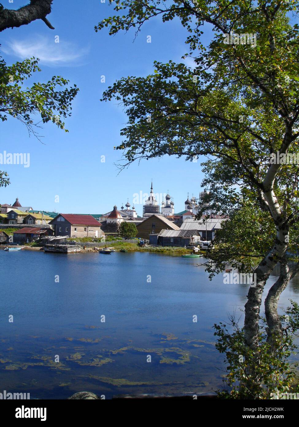 View from the shore of the White Sea to the Spaso-Preobrazhensky Solovetsky Monastery on a summer day framed by birch trees. Solovetsky Island. Arkhan Stock Photo
