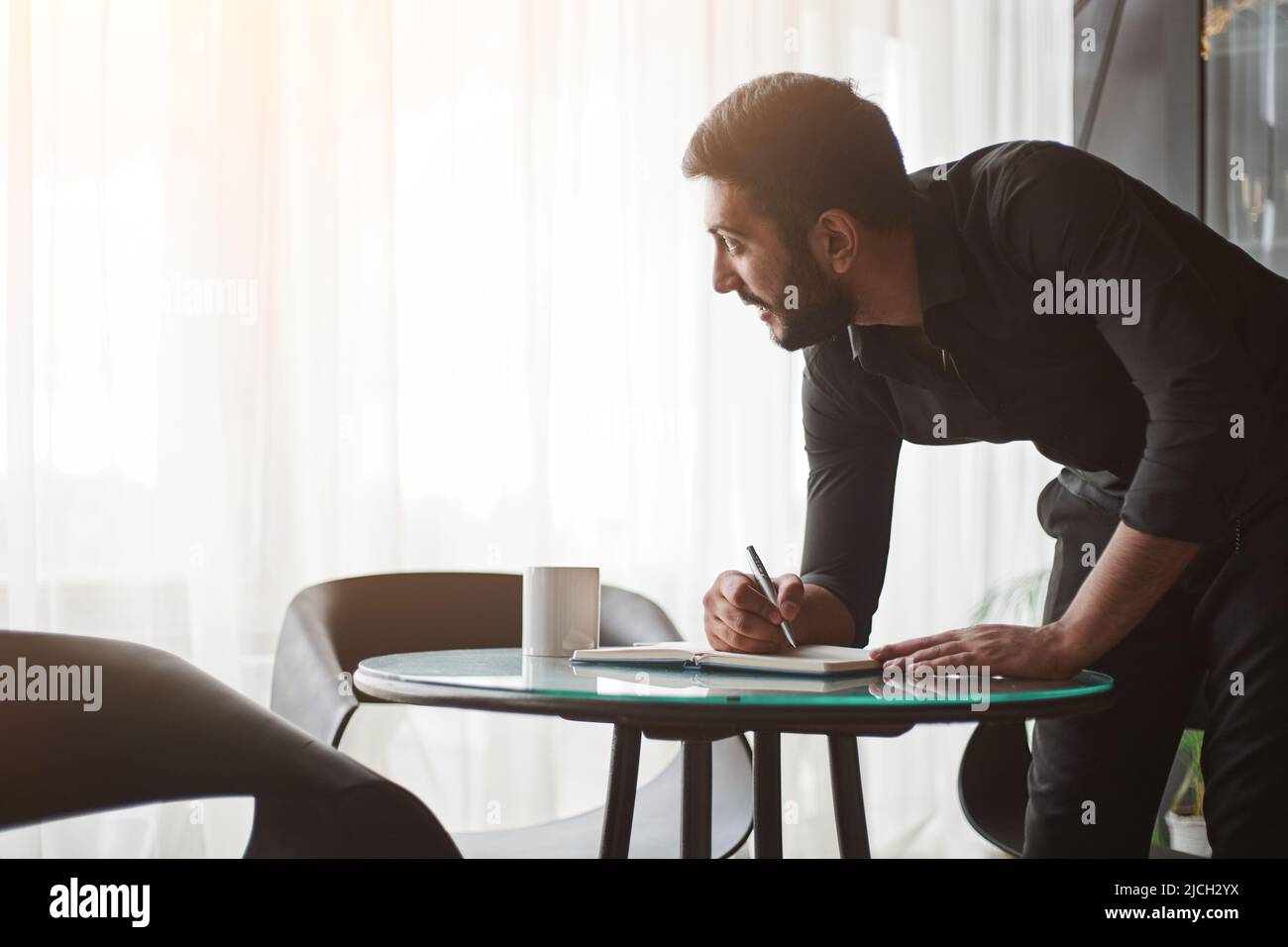 young business man taking notes in his notebook. Stock Photo