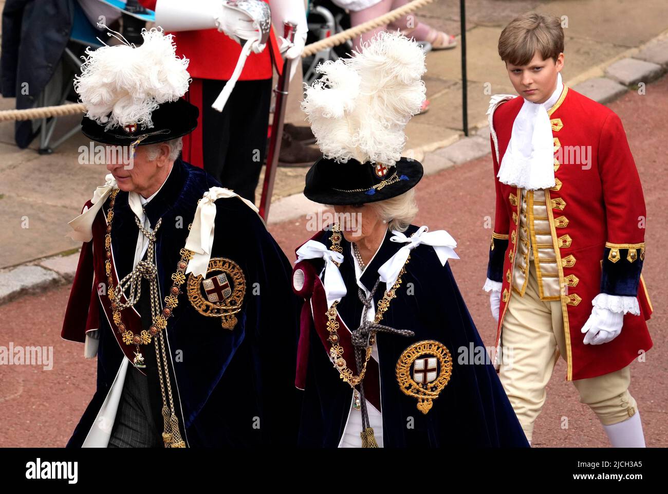 The Prince of Wales and the Duchess of Cornwall walk in the procession ahead of the annual Order of the Garter Service at St George's Chapel, Windsor Castle. Picture date: Monday June 13, 2022. Stock Photo