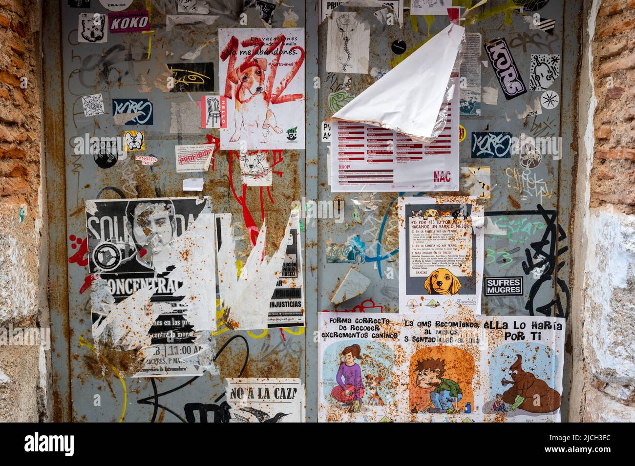 Old peeling posters and adverts on a wall in Spain Stock Photo