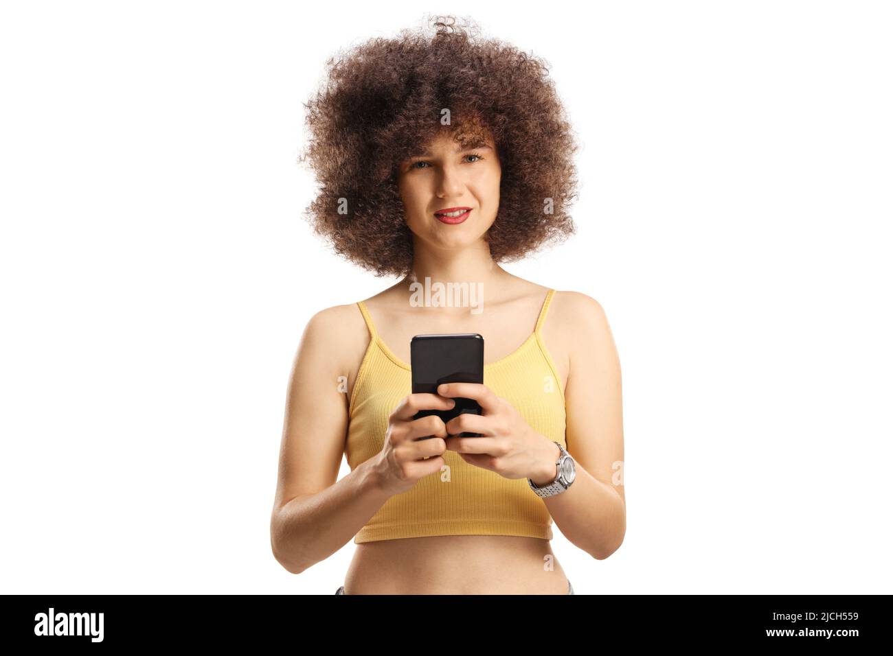 Young caucasian woman with afro hairstyle using a smartphone isolated on white background Stock Photo