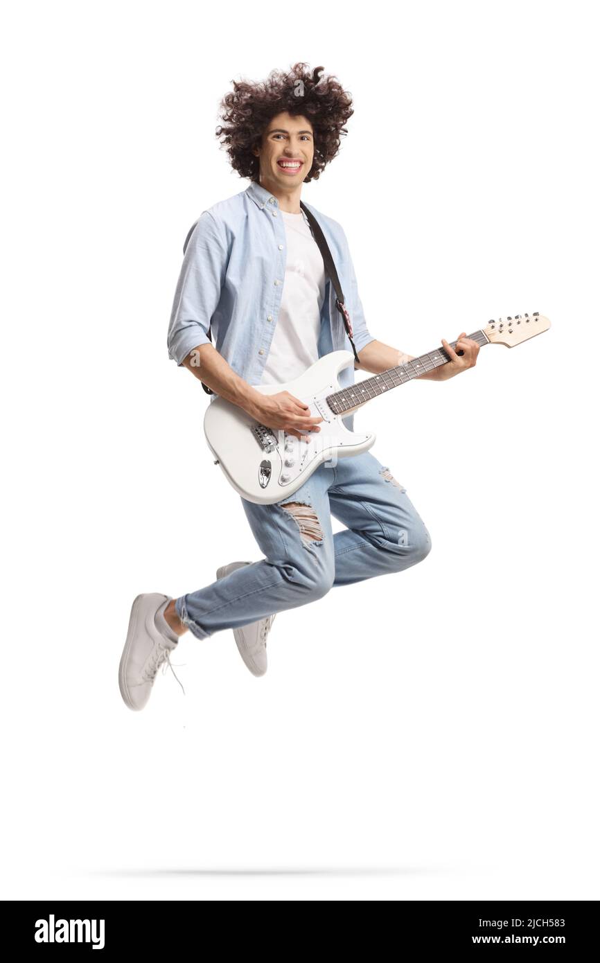 Casual young man jumping and playing an electric guitar isolated on white background Stock Photo