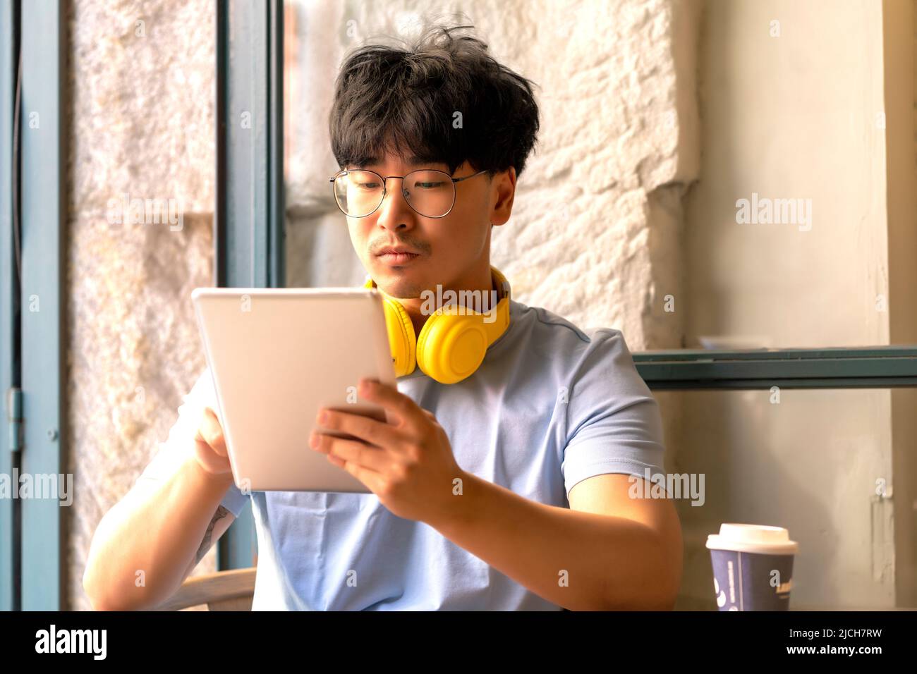 Asian teleworking while having a coffee Stock Photo