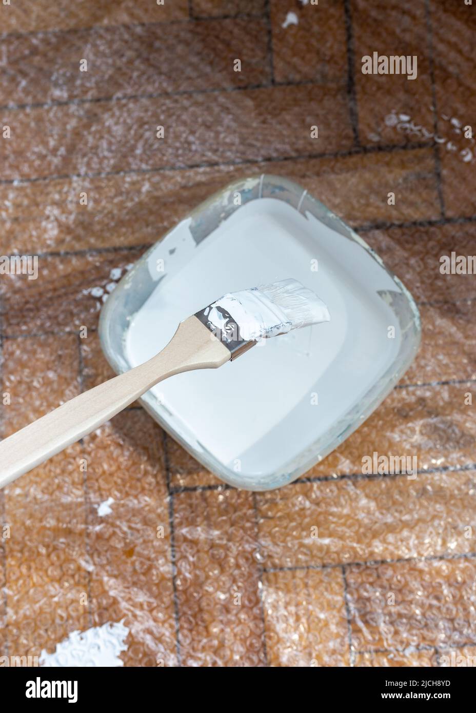 Radiator brush dipped in white paint. Brush painting Stock Photo Alamy