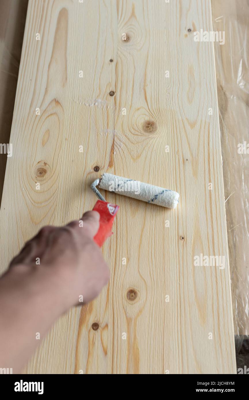 Coating the board with varnish using a roller Stock Photo Alamy
