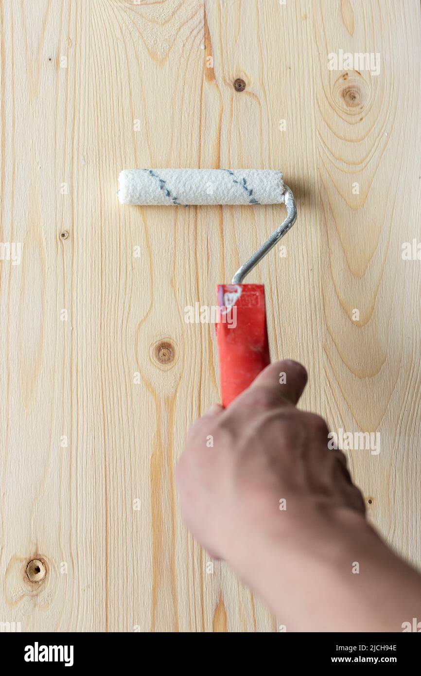 Coating the board with varnish using a roller Stock Photo Alamy