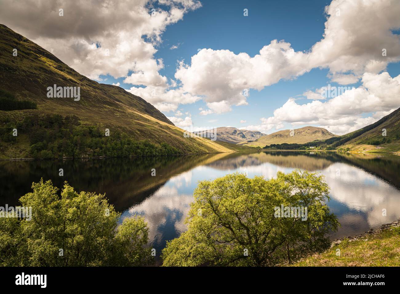 A tranquil, sunny, summer HDR image of reflections in Loch Beannacharain at the end of Strathconon in Ross-shire, Scotland. 02 June 2022 Stock Photo