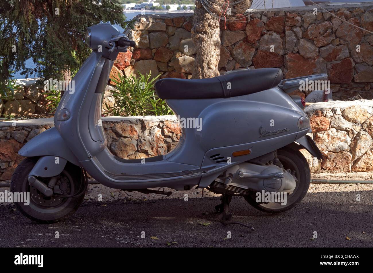 Vespa scooter parked by the roadside,, Tilos island Dodecanese, near Rhodes Greece Stock Photo